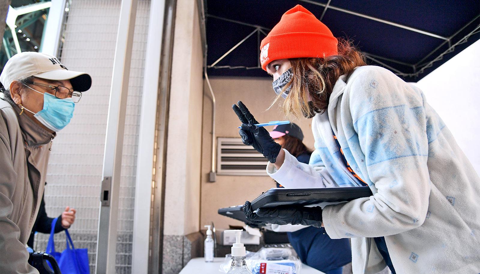 A food bank workers speaks to a person in line