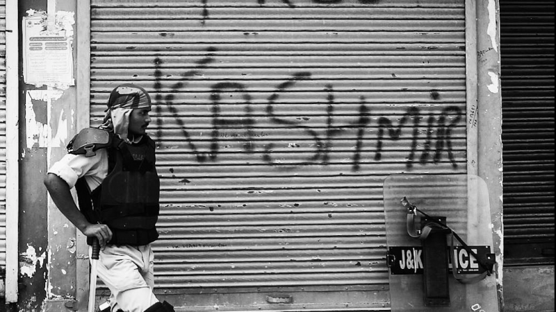 An Indian policeman stands near an alley in the uptown of Srinagar, the summer capital of Indian administered Kashmir. September 11, 2016. Image via Isntagram by Ieshan Wani. Used with permission.