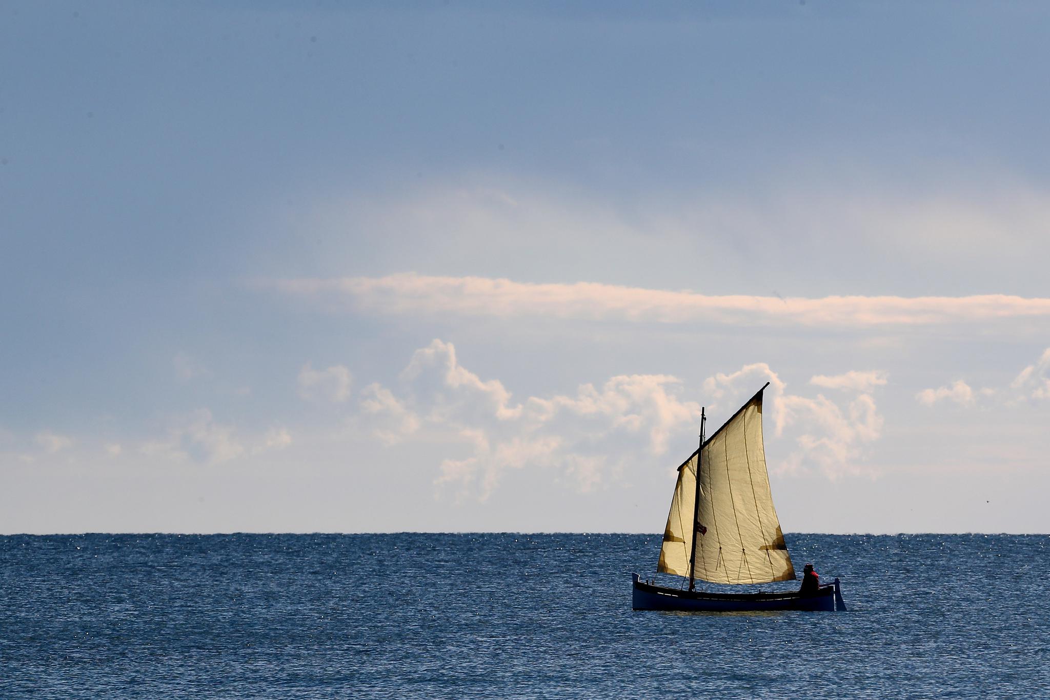 A man sails on a small boat on December 17, 2017, in the French riviera city of Nice.