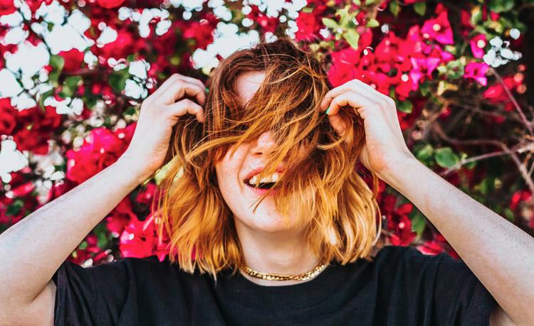 Happiness mistakes, by Sara Fabian. Photograph of person laughing by Tyler Nix