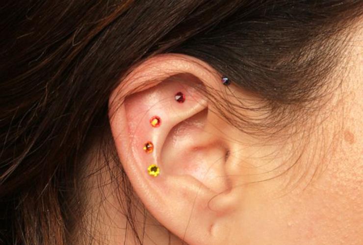 Ear Seeds: Can An Ancient Medicine Practice Promote Mind-Body Healing? by Maddison McKeever. Photograph of rainbow colored ear seeds, courtesy of Good Morning America