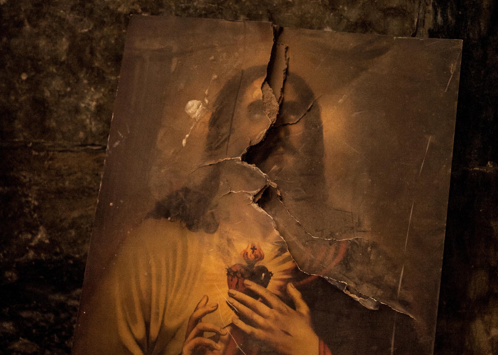 A picture of Jesus defaced by Islamic State militants lies on the floor of a church in Qaraqosh, the largest predominantly Christian city in Iraq. During its two-year occupation the group tried to erase all symbols of Christianity.