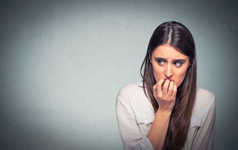 woman with anxiety biting her fingers