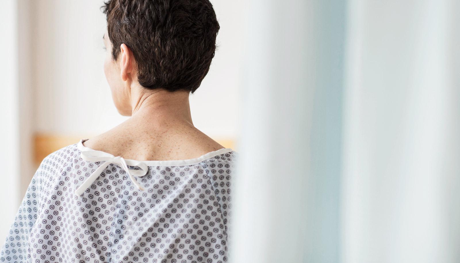 hospital patient in gown facing away