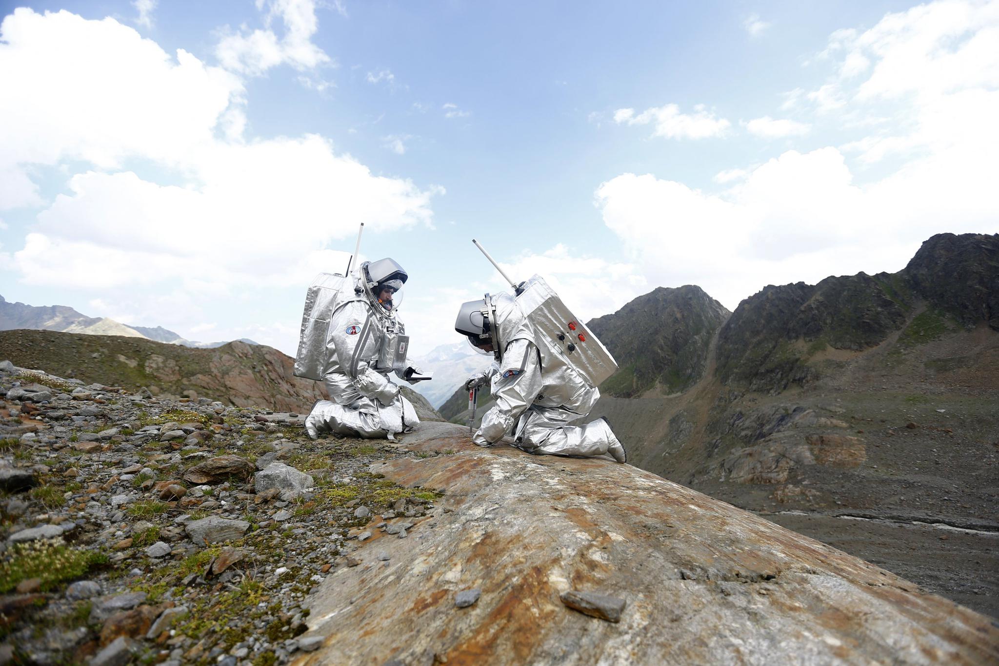 Researches sample stones on a simulated Mars mission in Austria, August 7, 2015. European astronomers are proposing a drone mission to gather images of the Martian landscape.