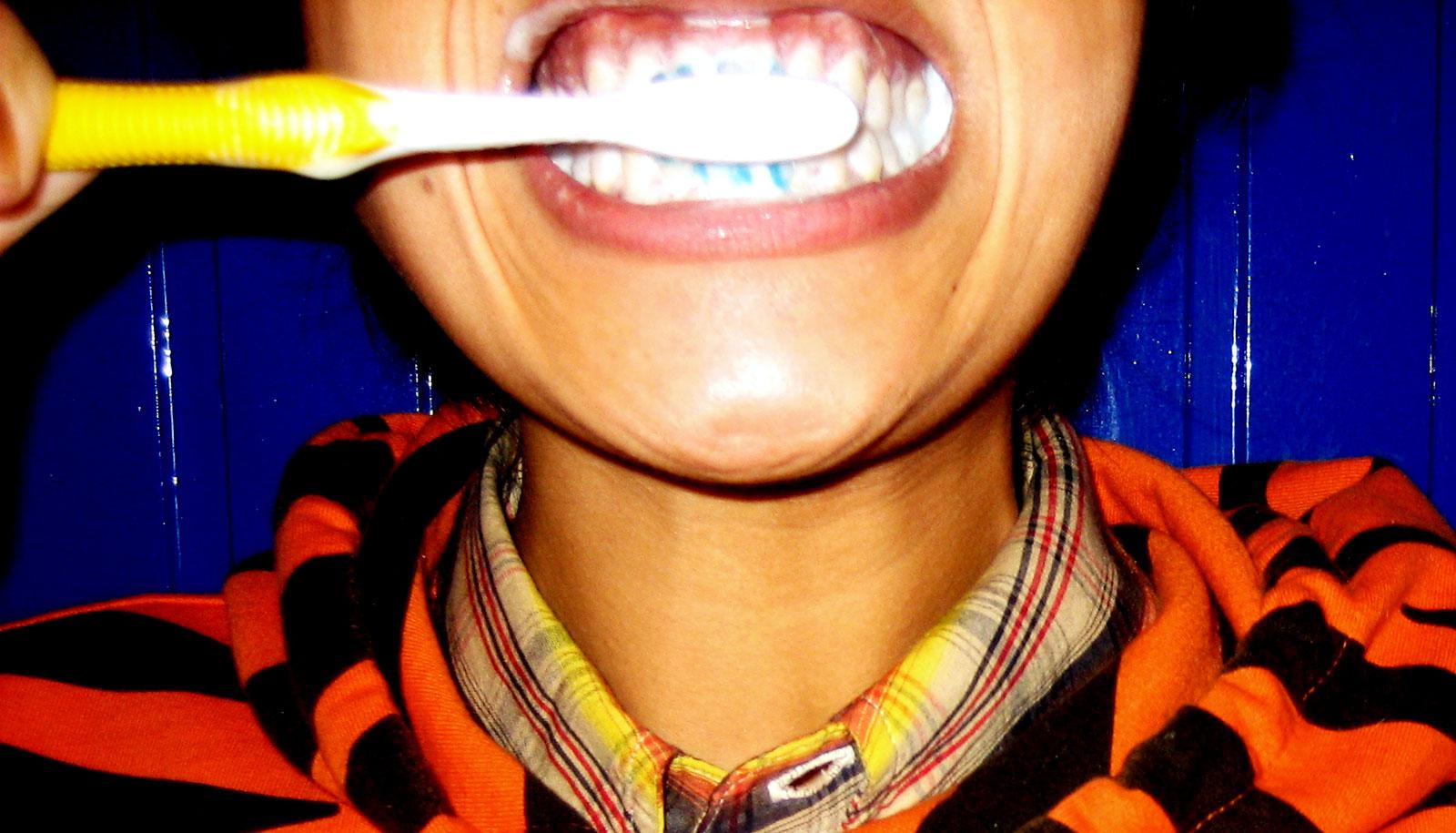 brushing teeth in tiger hoodie (triclosan concept)