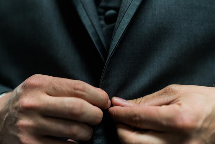 The Return of the Gentleman: The Art of Living Authentically, by Dain Heer. Photograph of man's hands buttoning a suit coat by Andre Hunter