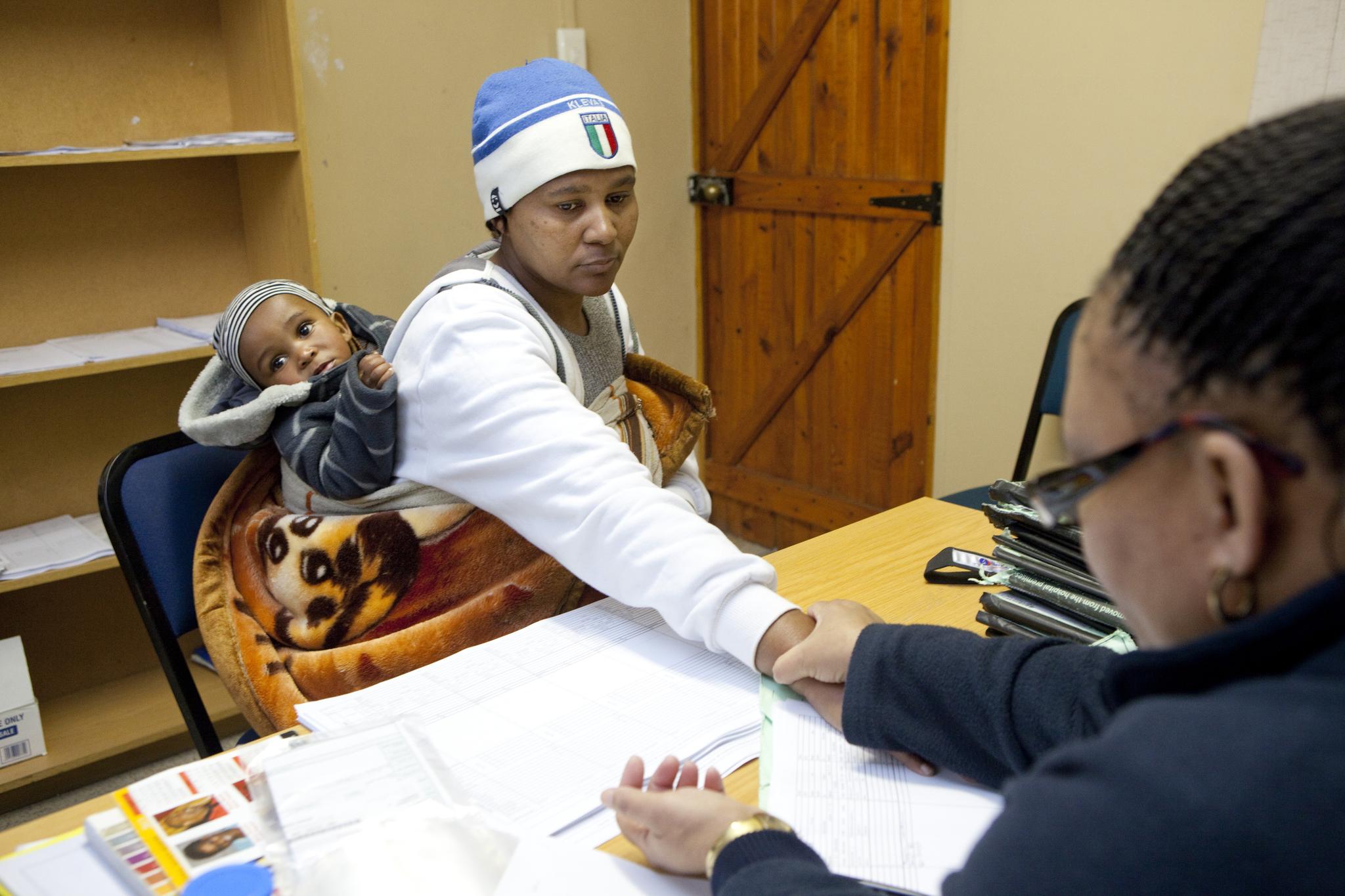 A woman who was diagnosed with the HIV virus has her heart rate checked during a consult with a nurse at Ubuntu Clinic on June 3, 2013 in Cape Town, South Africa. She is a member of a support group, called an adherence club, for stable patients.