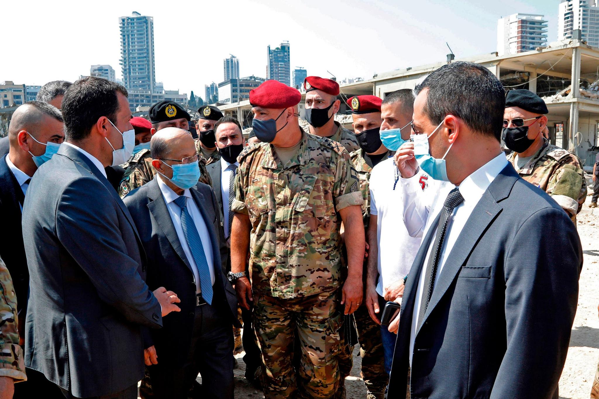 Lebanon's President Michel Aoun (3rd L) wears a protective face mask as he visits the site of a massive explosion (AFP via Getty Images)