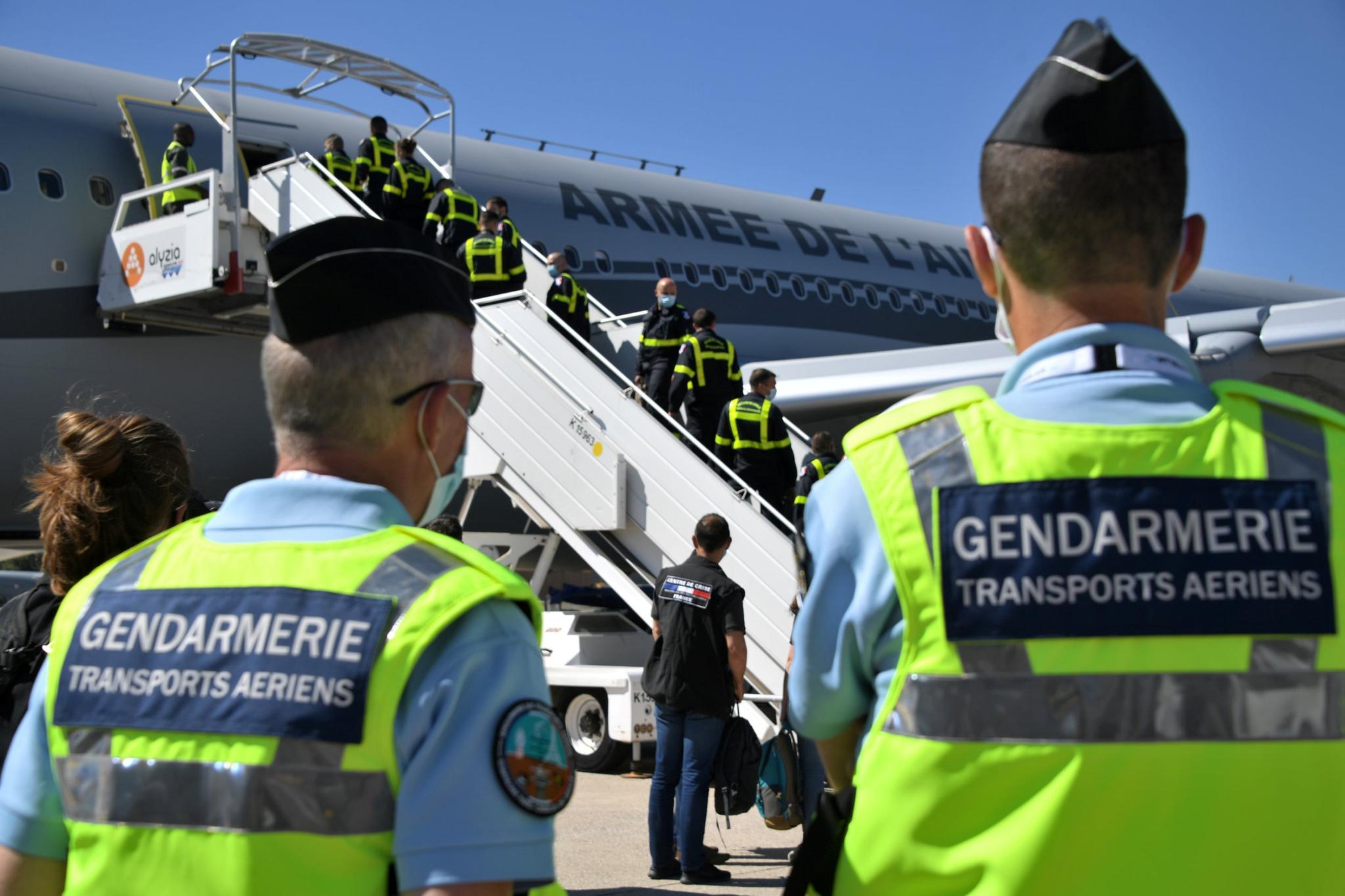 French gendarmes look at Securite Civile (Civil Security) personnel boarding an Airbus A330 as France sends search and rescue experts (REUTERS)