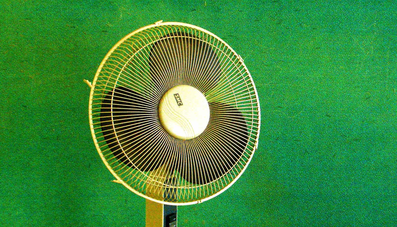 fan in front of green wall