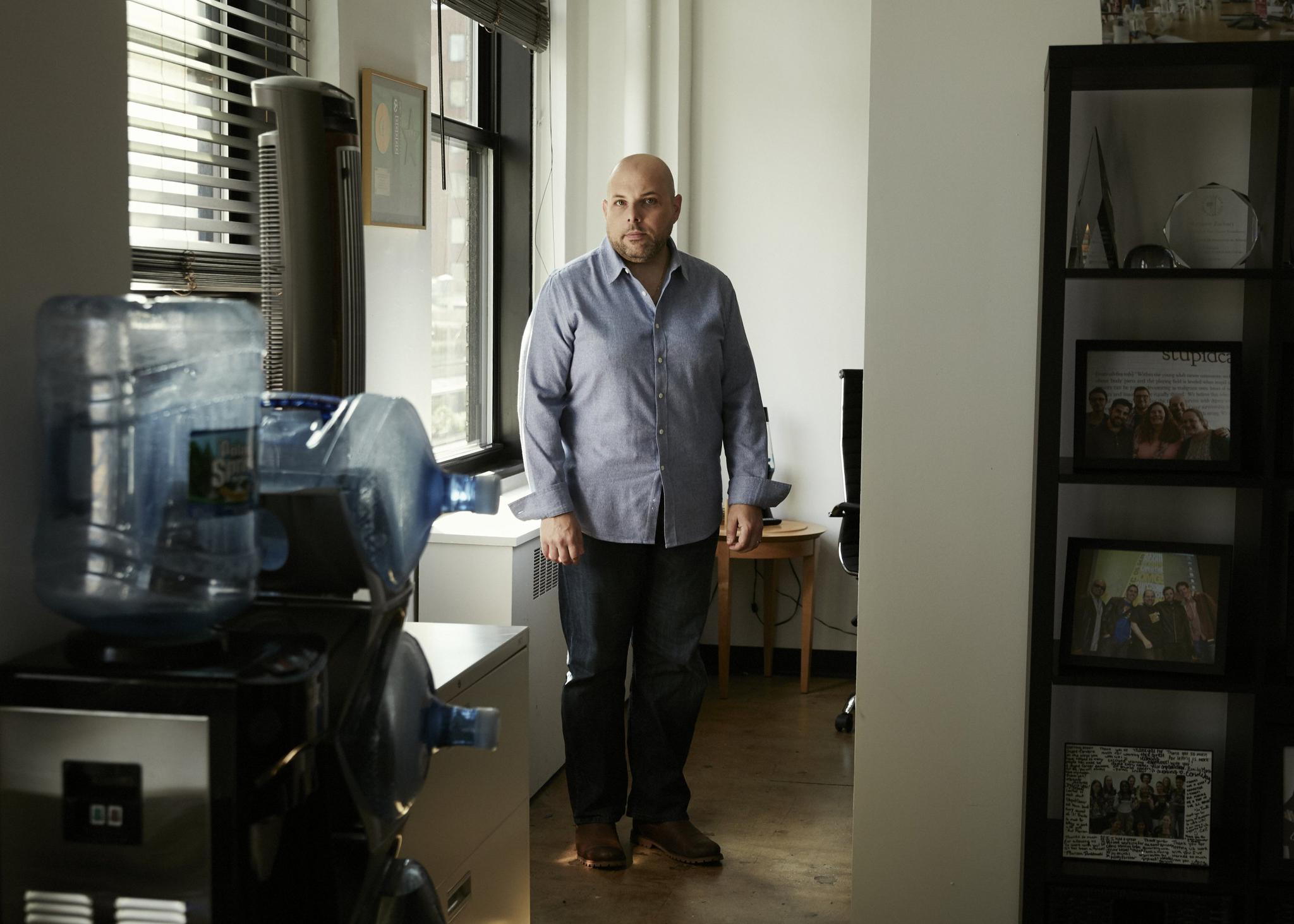 Matthew Zachary poses in the meeting room of Stupid Cancer's office in Tribeca, New York.