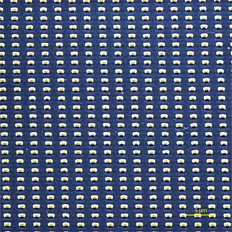 A scanning electron microscope image shows submicron-scale cavities patterned into films of aligned carbon nanotubes