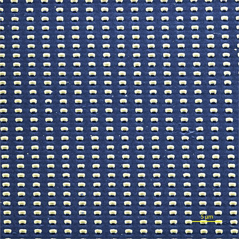 A scanning electron microscope image shows submicron-scale cavities patterned into films of aligned carbon nanotubes