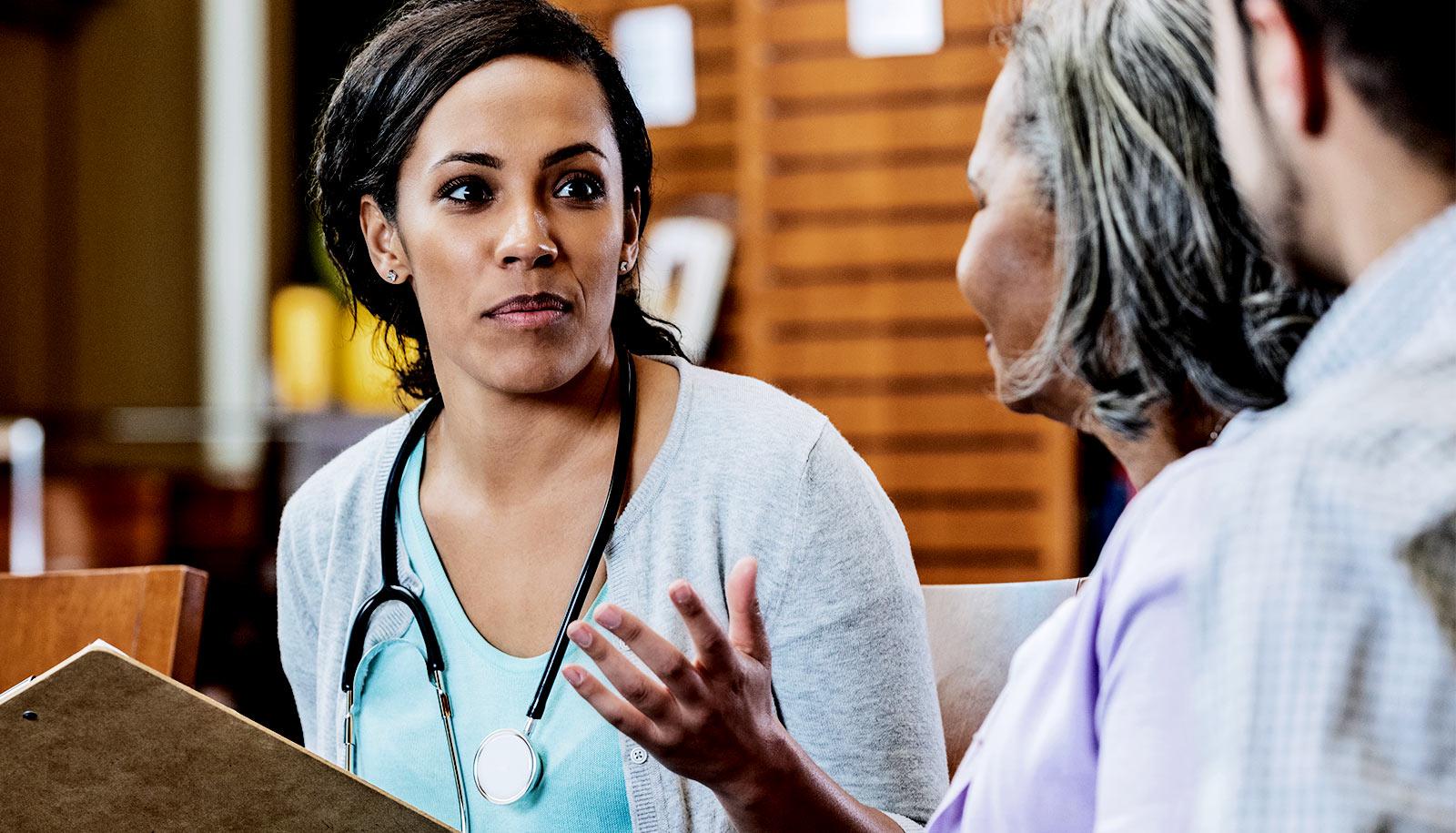 A doctor speaks to a group of patients