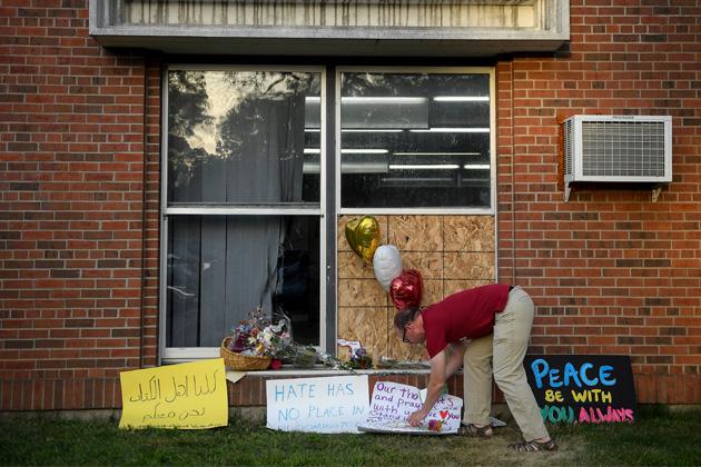 Signs of support are shown near the window that was damaged during an attack at the Dar Al-Farooq Islamic Center in Bloomington, Minnesota, on Aug. 5. (Aaron Lavinsky/Star Tribune via AP)