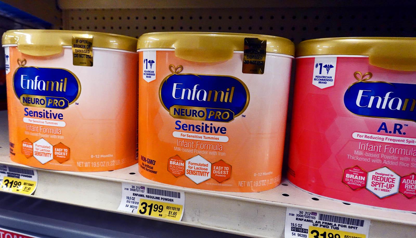 canisters of baby formula on a shelf