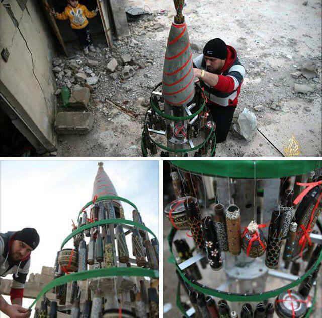 Akram Abo Alfoz decorates a Christmas tree in besieged Douma. December 24, 2016. Source.