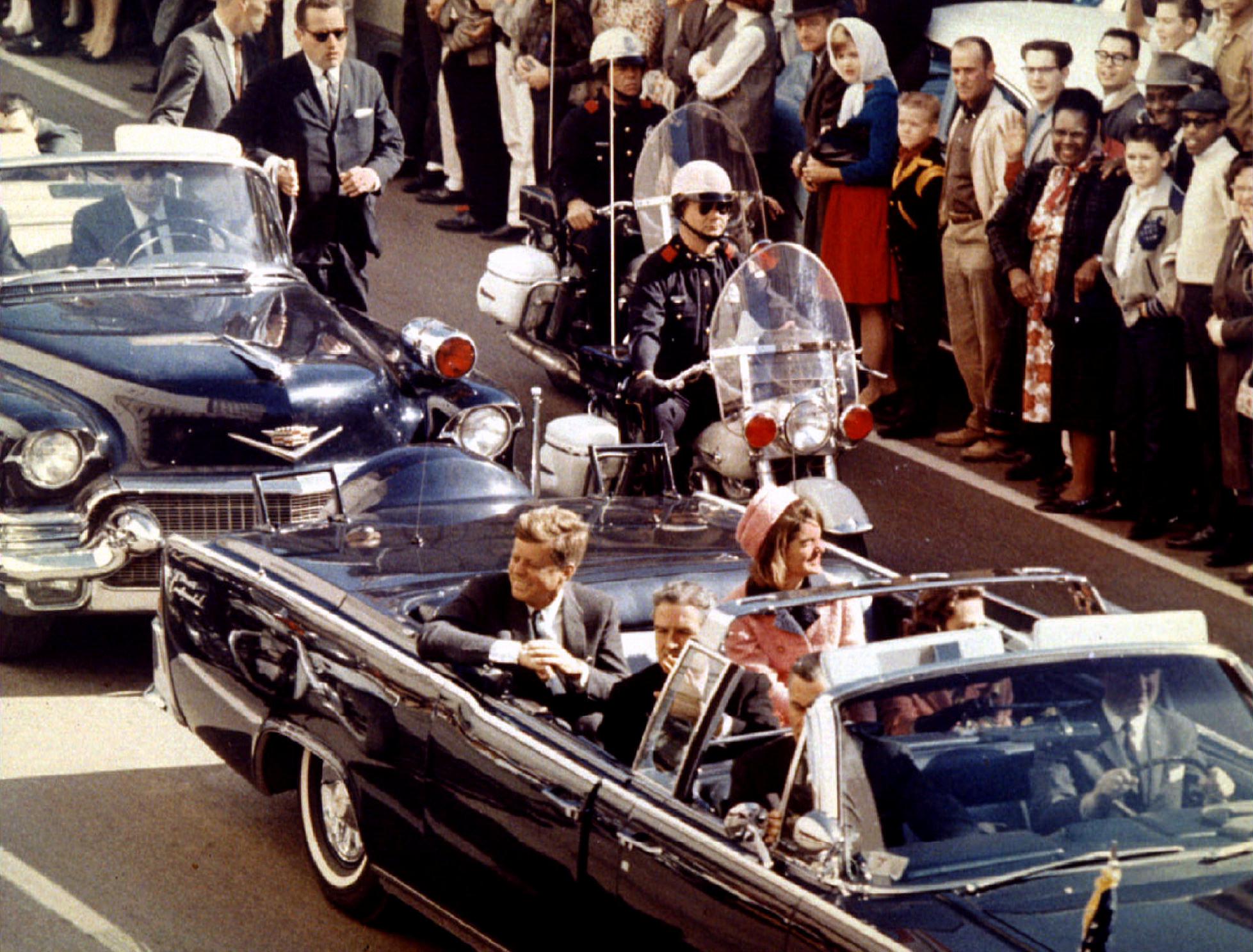 President John F. Kennedy, First Lady Jacqueline Kennedy and Texas Governor John Connally ride through Dallas moments before Kennedy was assassinated on November 22, 1963.