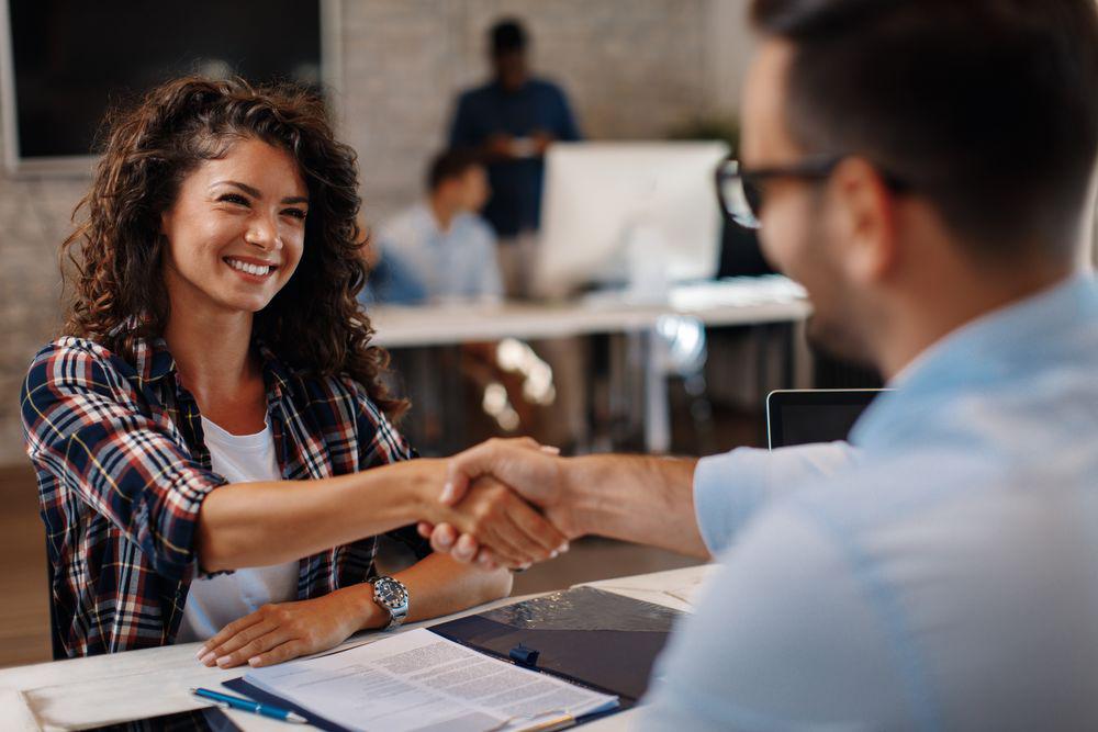 Woman shaking hands in an office