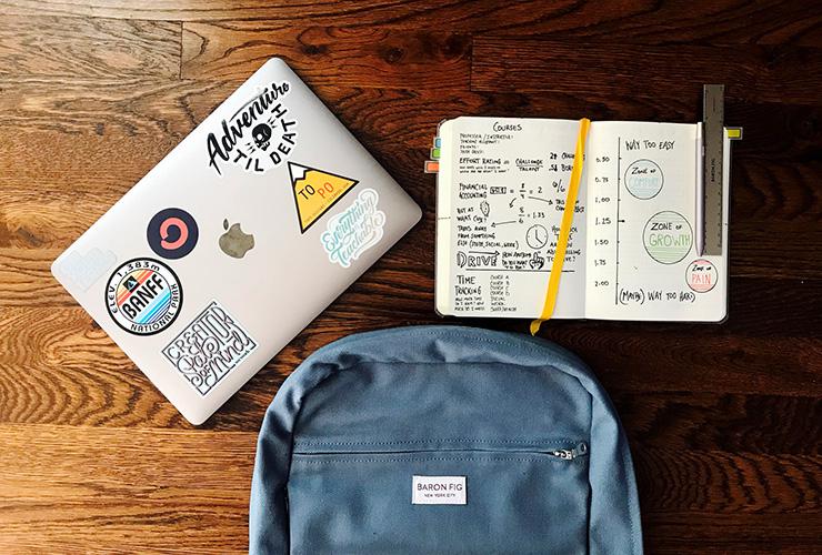 7 Esssential Healthy Living Tips for College Students by Jenine Wingg. Photograph of a laptop, book bag and journal by Matt Ragland