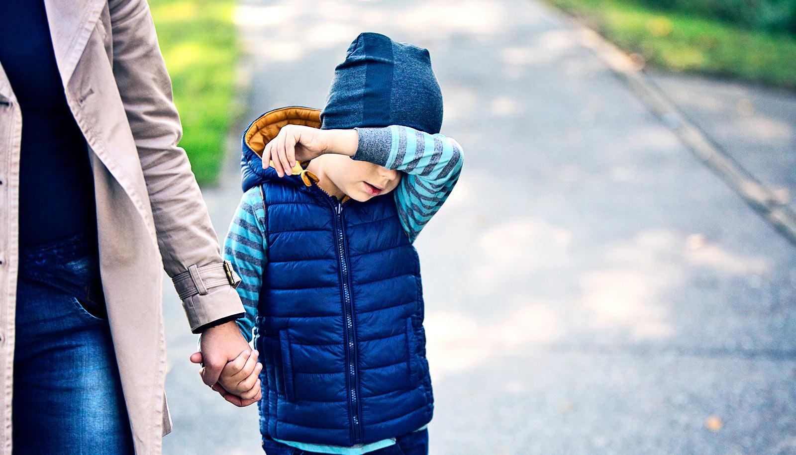 young sad boy with mom