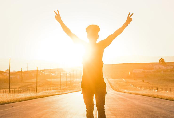 Healthy life, health living. Photograph of man with hands up by Wesley Eland