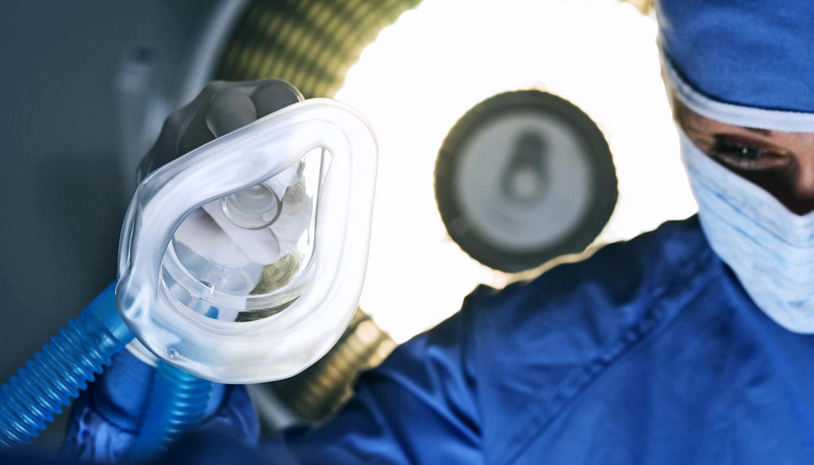 surgeon holding anesthesia mask