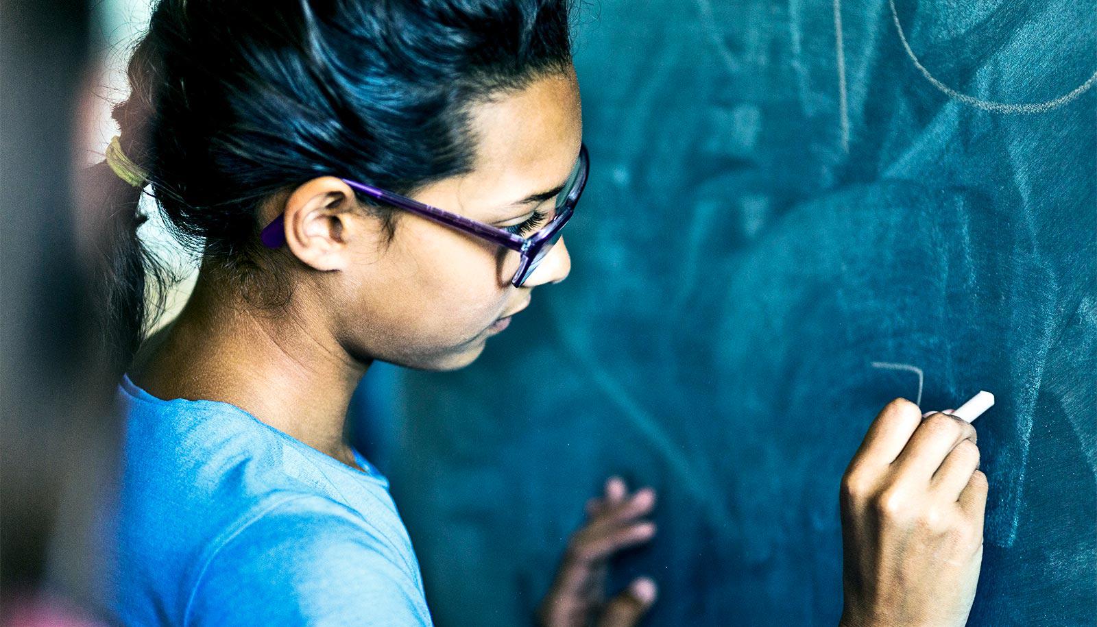 young girl at blackboard