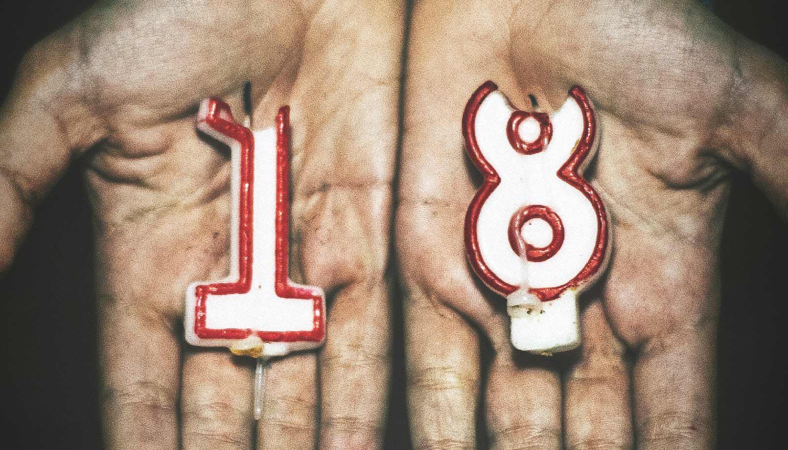 "18" candles in palms of hands