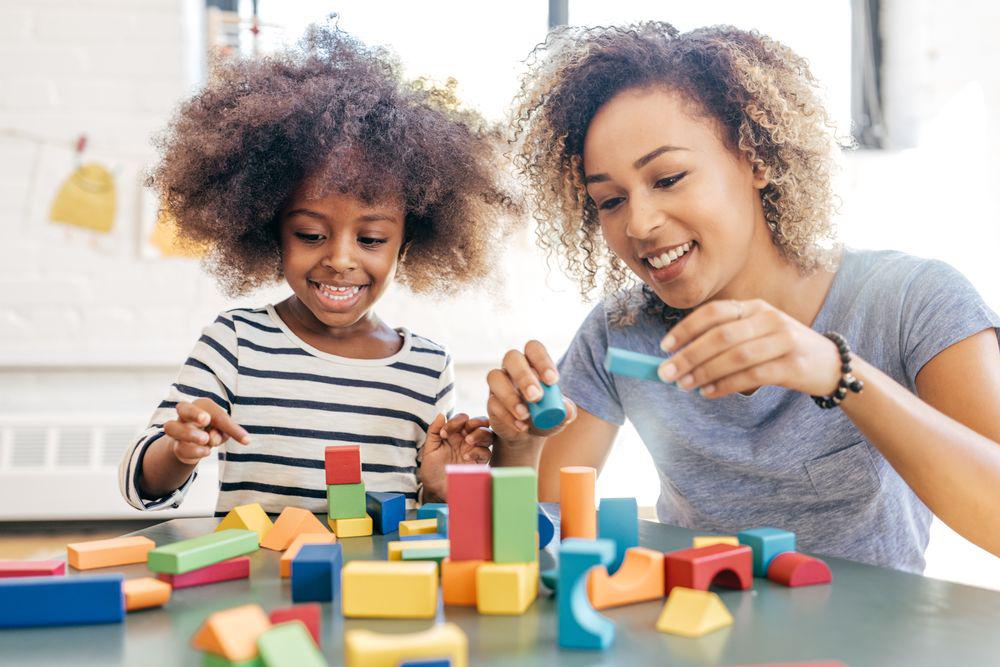 mom and kid playing with building blocks