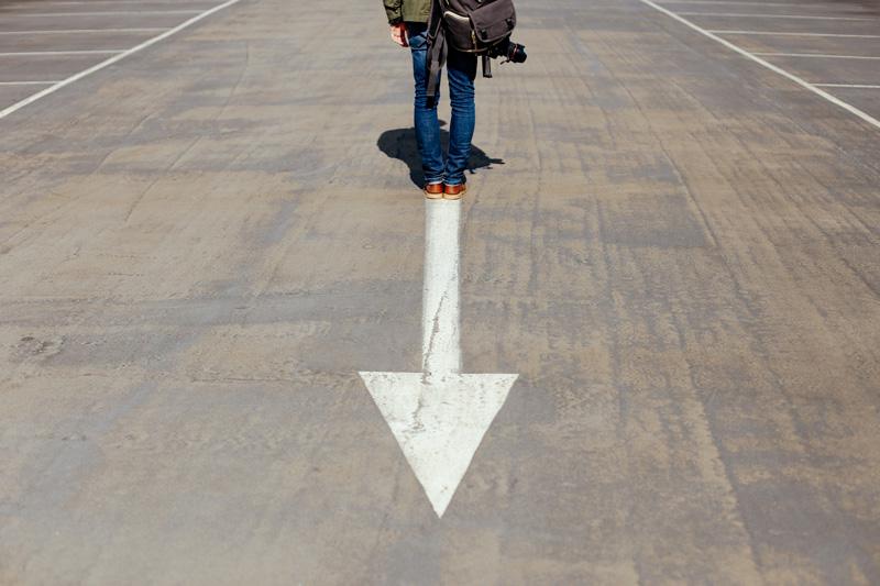 Why Letting Go of Aspects of Your Past is So Hard and How to Make It Easier, by Jori Hamilton. Photograph of person walking away from an arrow by Smart