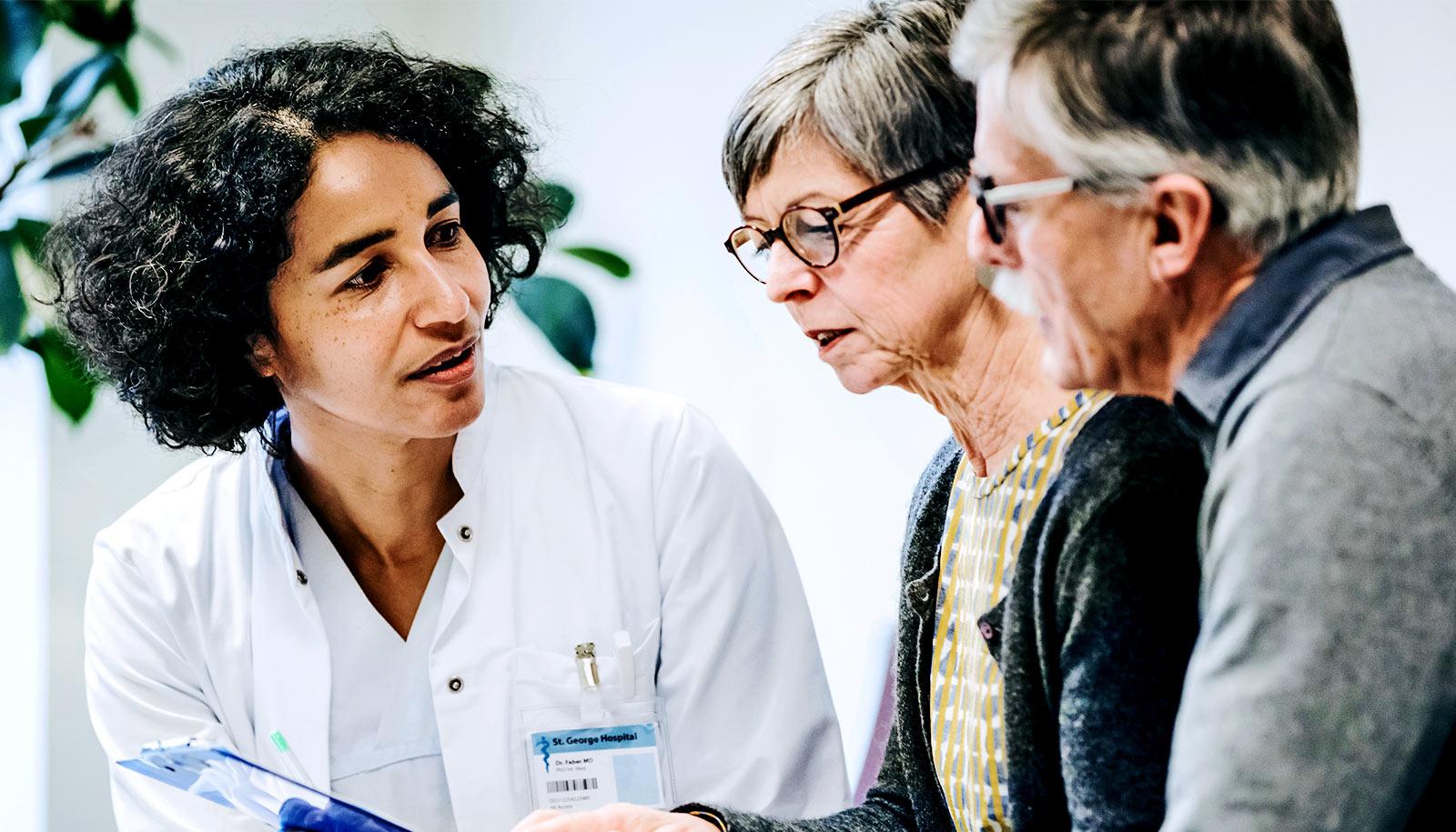 doctor talking to older couple