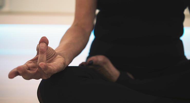Meditation is Your Best Productivity Tool, by Tom Caklos. Photograph of woman meditating by JD Mason