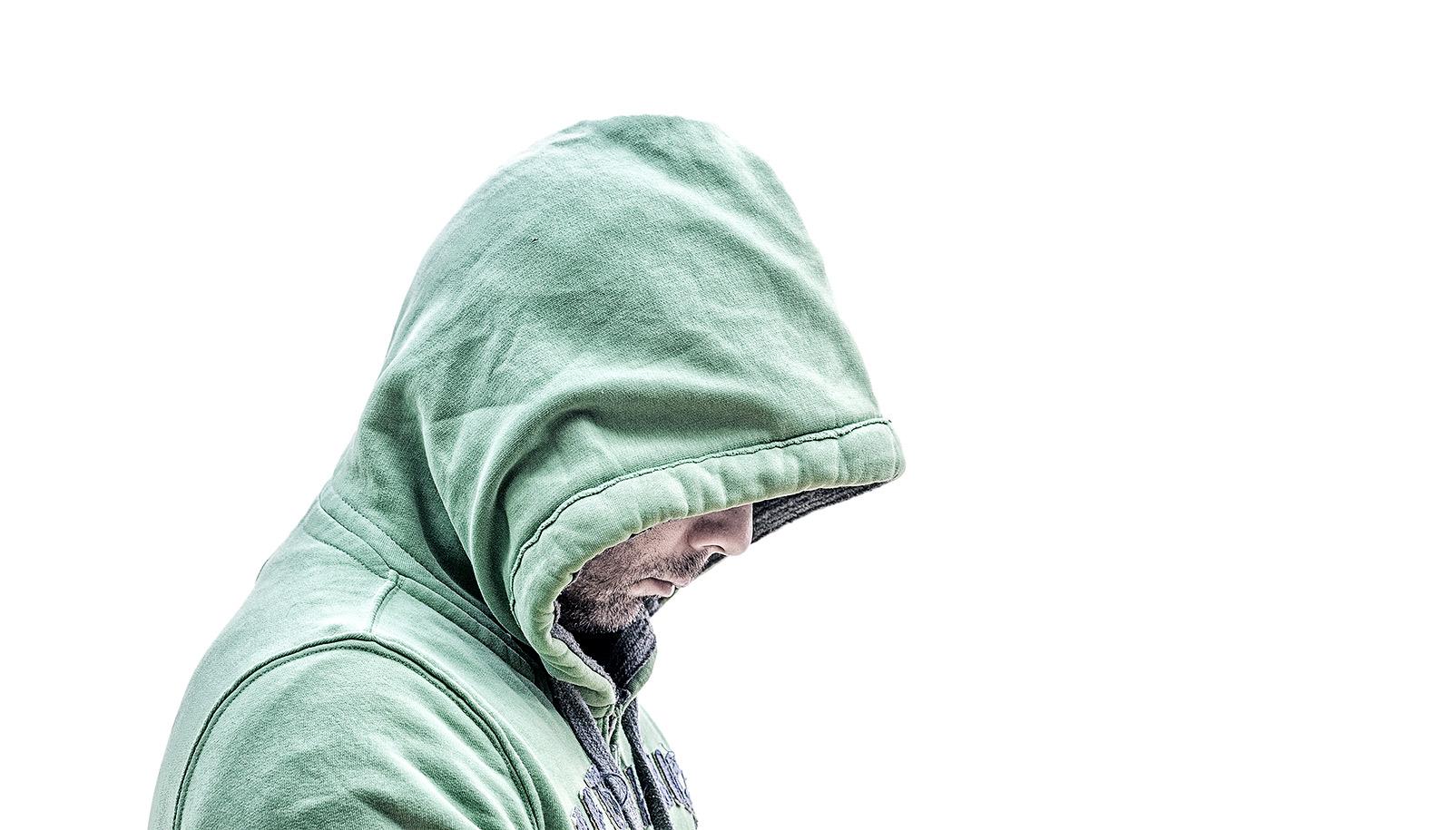 hooded man looking down