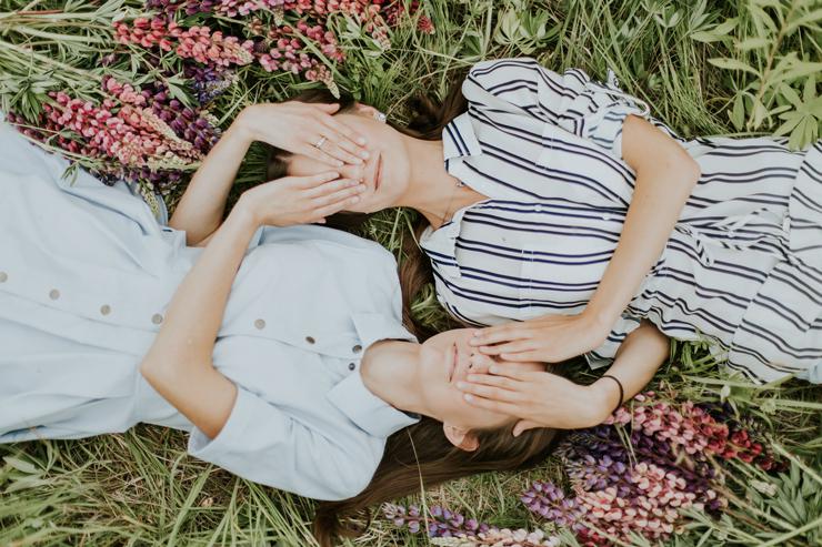 In service of others, helping loved ones overcome their demons; photograph of two women in field by Daiga Ellaby