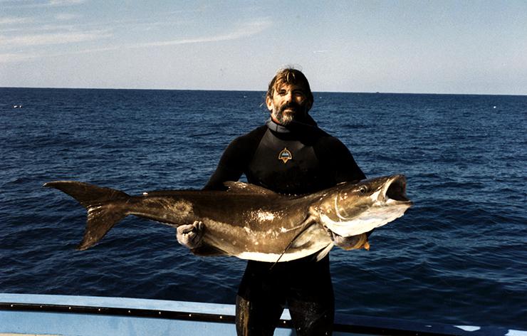 fisherman holds fish