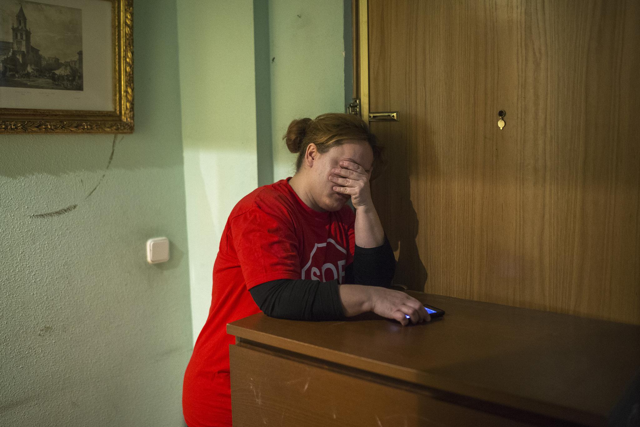 Rosario Echevarria Pedrezuela, 35, tries to stop police from entering the apartment she has occupied for the last ten months with her husband and their two children after they were evicted from their previous home in Madrid on Feb. 16, 2015.