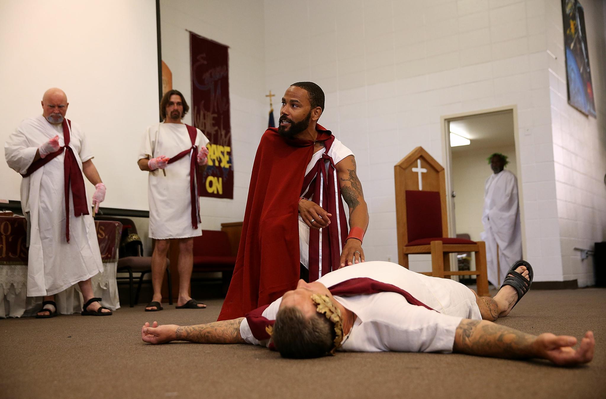 San Quentin State Prison inmate LeMar Harrison, center, plays Mark Antony in a production of Shakespeare's Julius Caesar at San Quentin State Prison on May 15, 2015. Under the direction of Shakespeare for Social Justice, San Quentin State Prison inmates are performing Shakespearean plays for inmates and a select audience of outside guests.