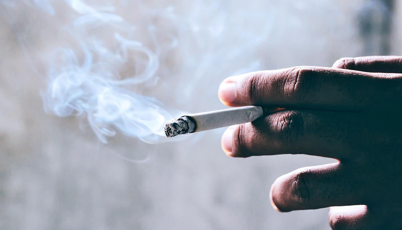 cigarette burning in hand