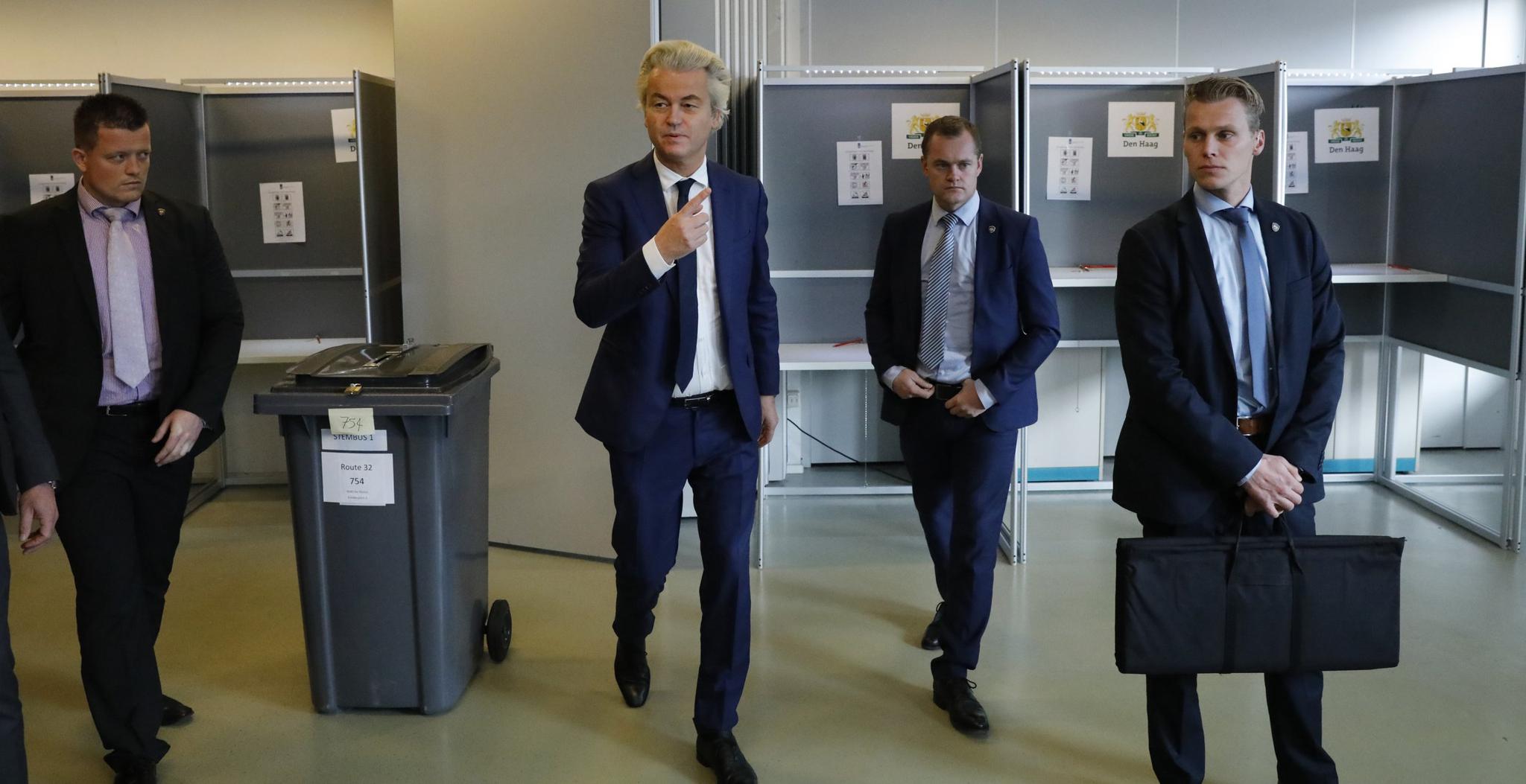 Dutch far-right politician Geert Wilders of the PVV party is surrounded by security as he votes in the general election in The Hague, Netherlands, on March 15.