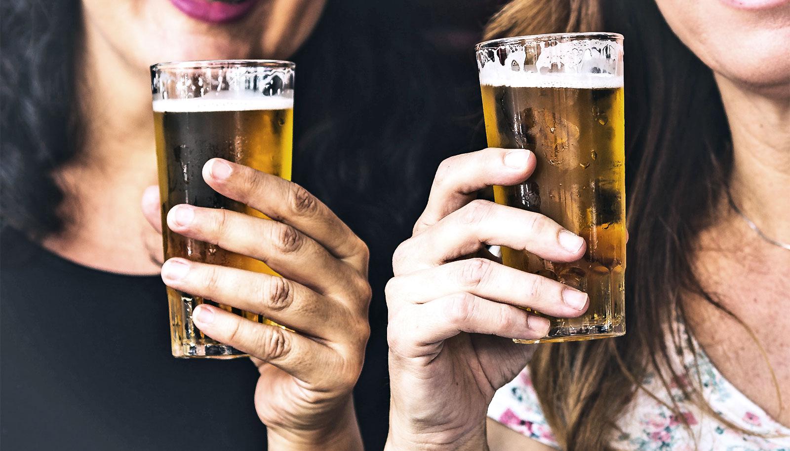 two women holding beer